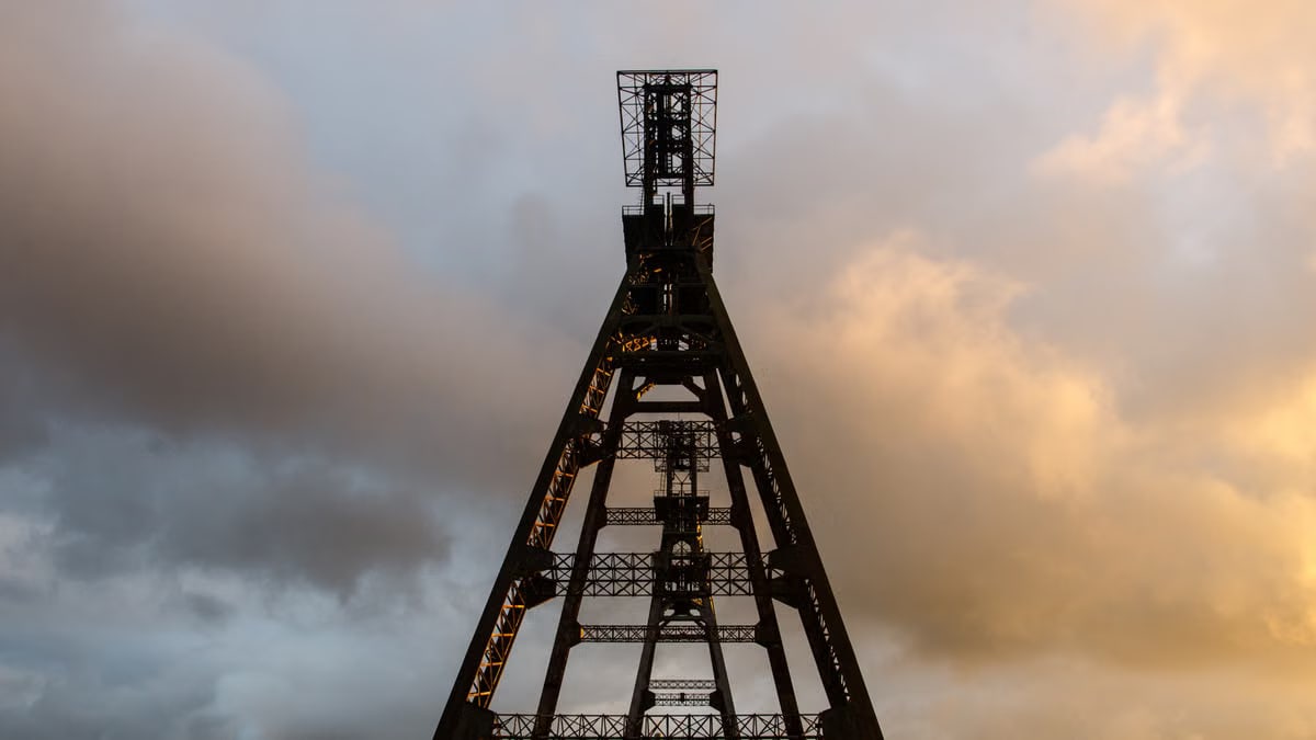 Iron lattice structure silhouetted against a dramatic sunset in Heusden-Zolder, Belgium.