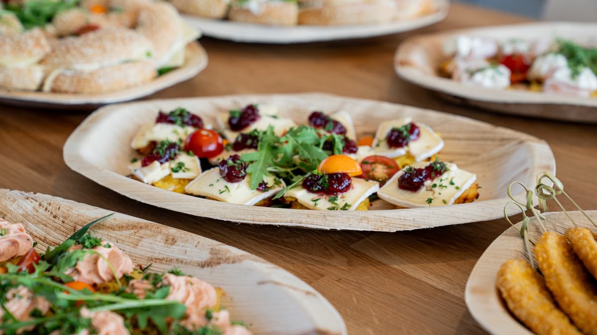 A variety of fresh appetizers on a wooden table, perfect for parties and gatherings.